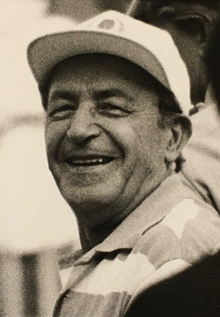 An old black and white photo of a man smiling.