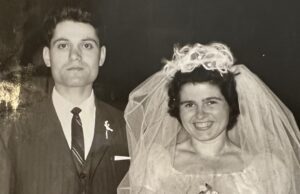 An old photo of a man and woman posing for a picture.