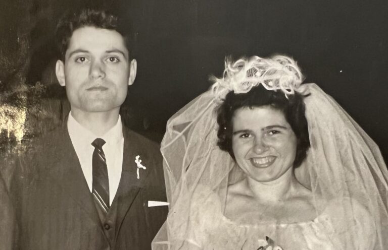An old photo of a man and woman posing for a picture.