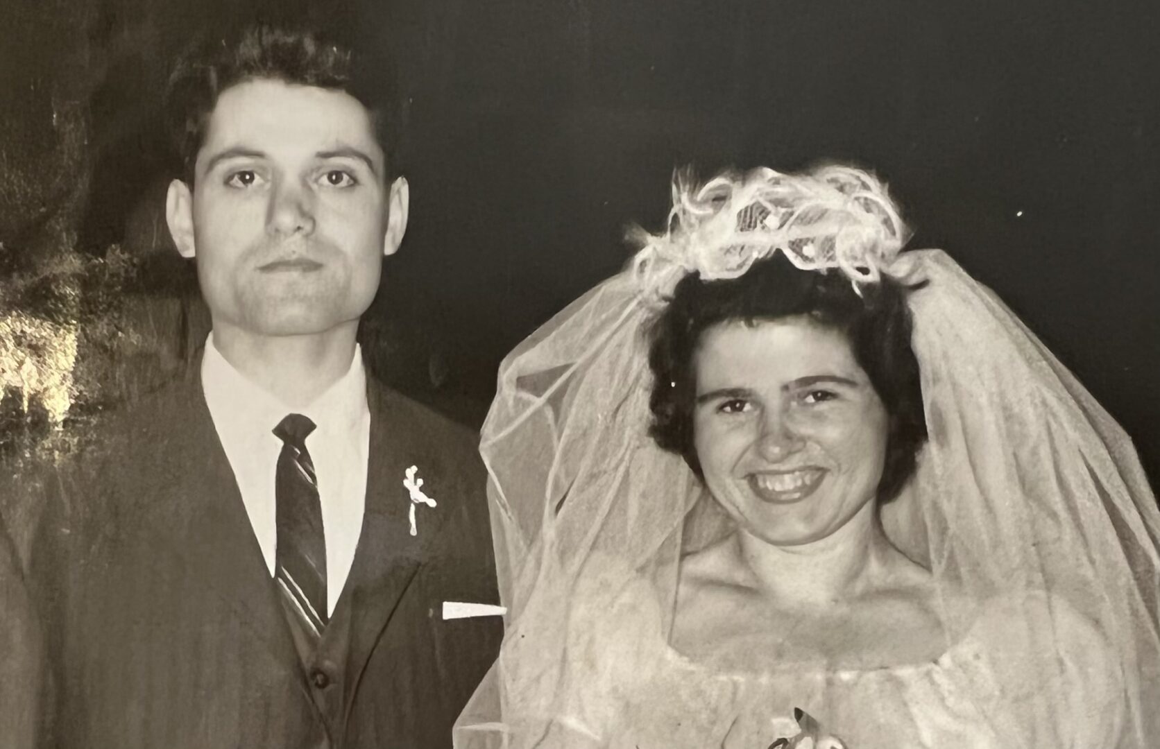 An old photo of a man and woman posing for a picture.