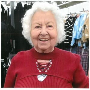 Lilly Kretsos, an older woman, smiling in a clothing store.