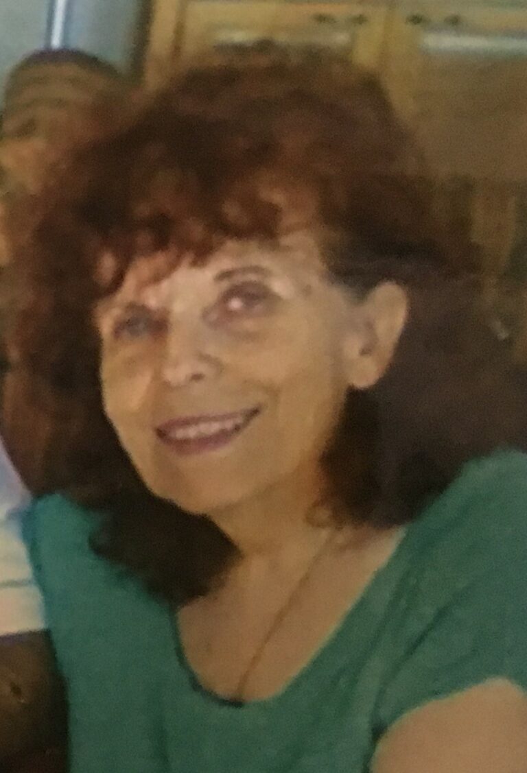 An older woman named Lilly Kretsos is smiling for the camera.