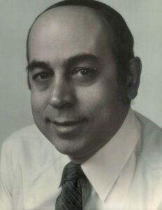 A black and white photo of Helen Karkazis in a tie.