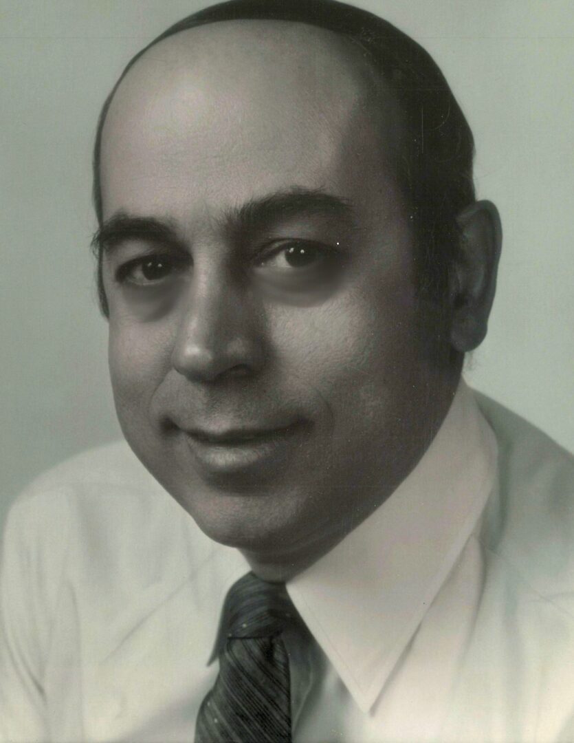 A black and white photo of Helen Karkazis in a tie.