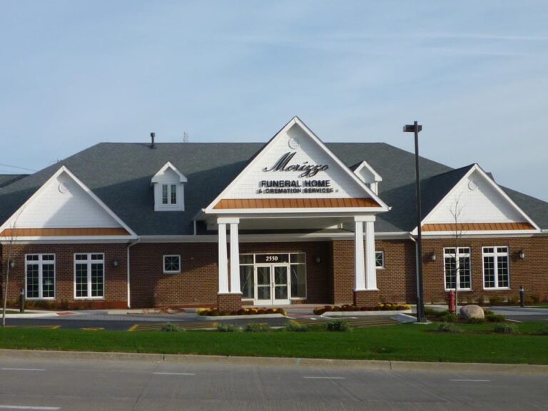 A brick building with a white roof and white trim.
