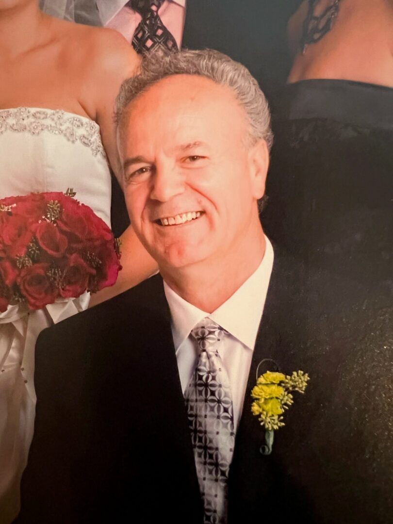 An old man with a flower near the collar