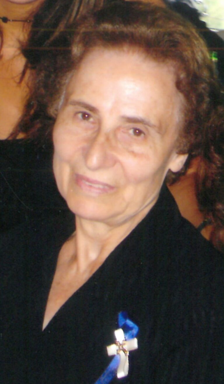 Close up shot of an old lady wearing coat, smiling