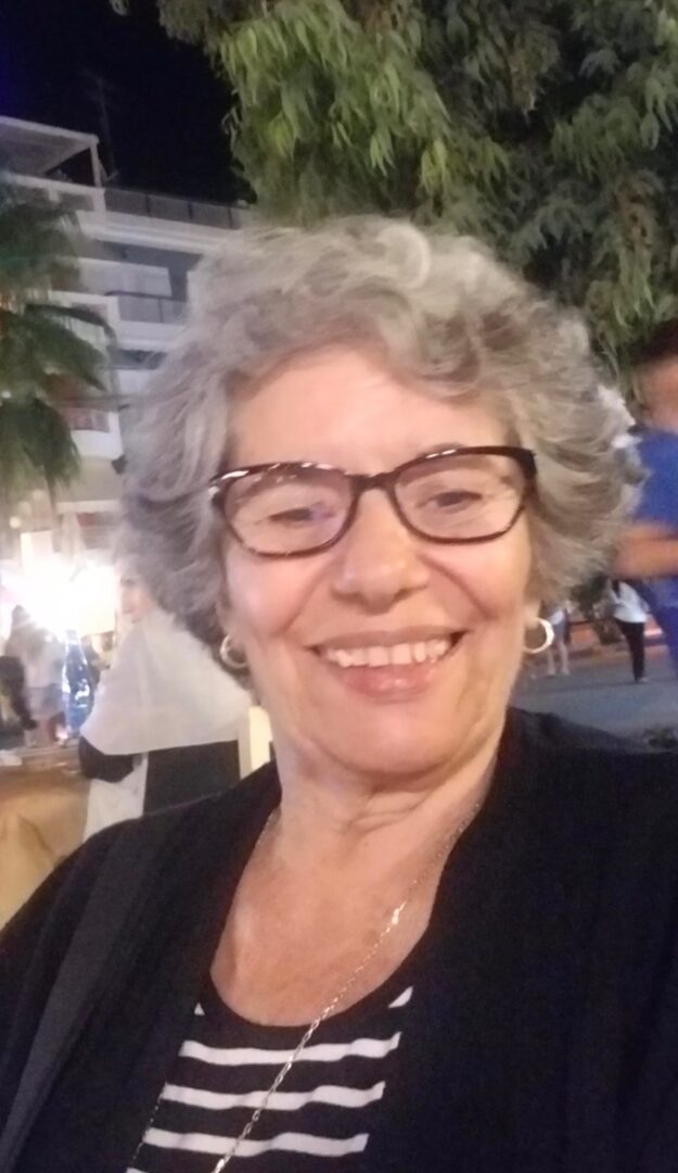 An old woman with white hairs and a spectacle