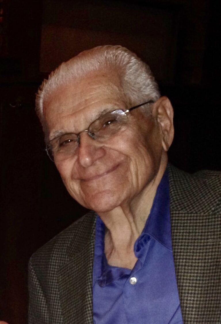 Close up image of an old man wearing a brown coat