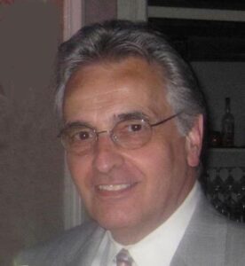 Close up image of an old man wearing a suit