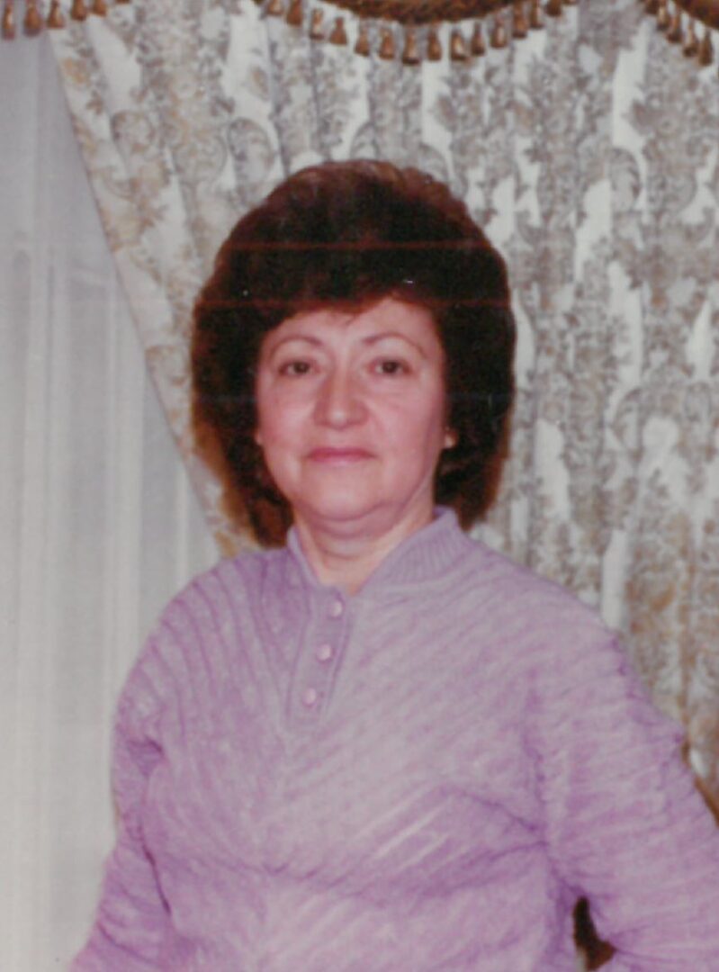 A woman wearing a purple sweater.