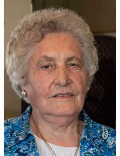 An older woman wearing a blue shirt.