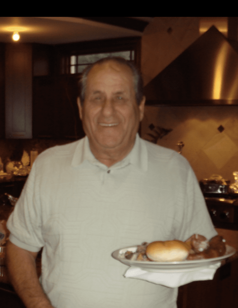 A man holding a plate of food.