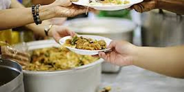 Serving food at a communal meal or event.