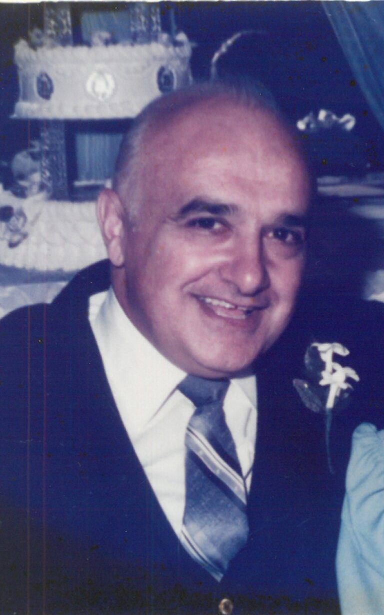 Smiling man in a suit and tie.