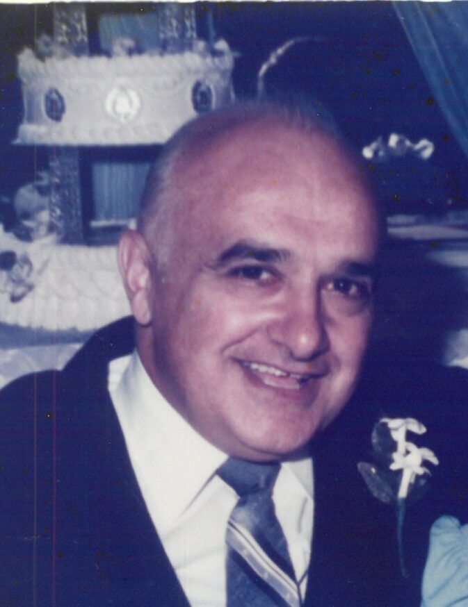 Smiling man in a suit and tie.
