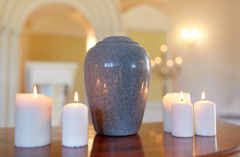 Cremation urn with candles burning in church