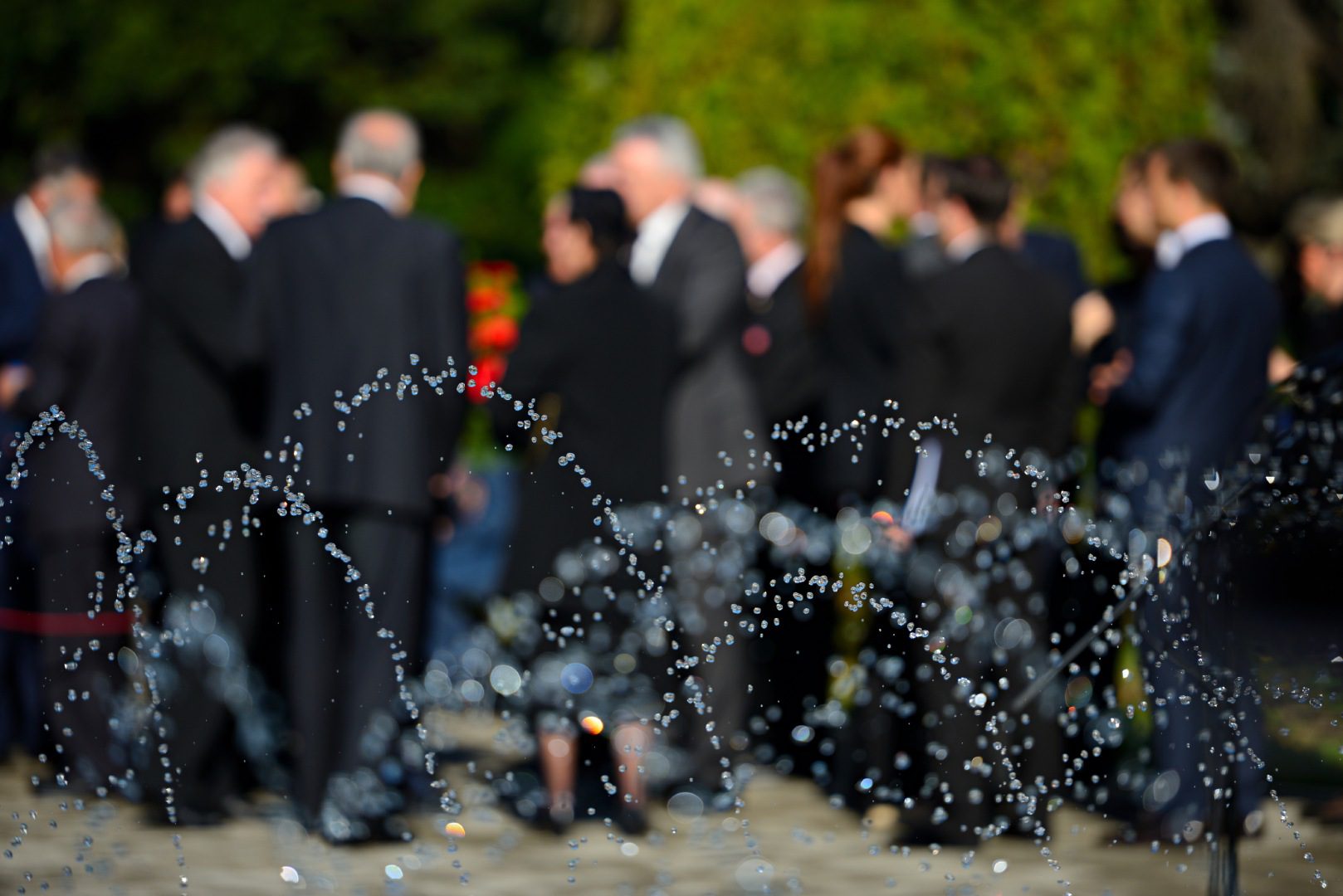 Water splashing in the air along with people on background